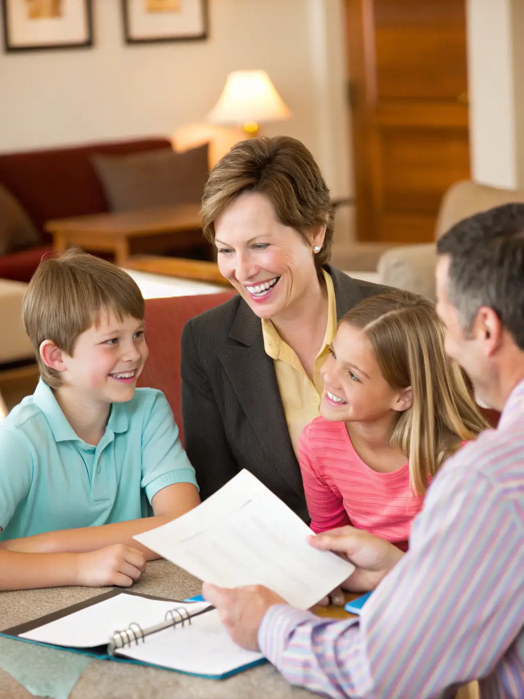 A family discussing financial plans with a consultant in a comfortable setting, emphasizing the importance of wealth management and financial security for future generations.